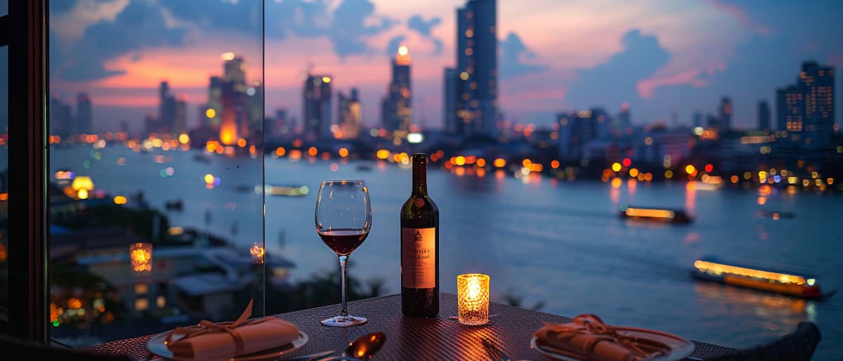 A Royal Affair: The History of Wine in Thailand 5 A bottle of wine in front of the Bangkok skyline at night.